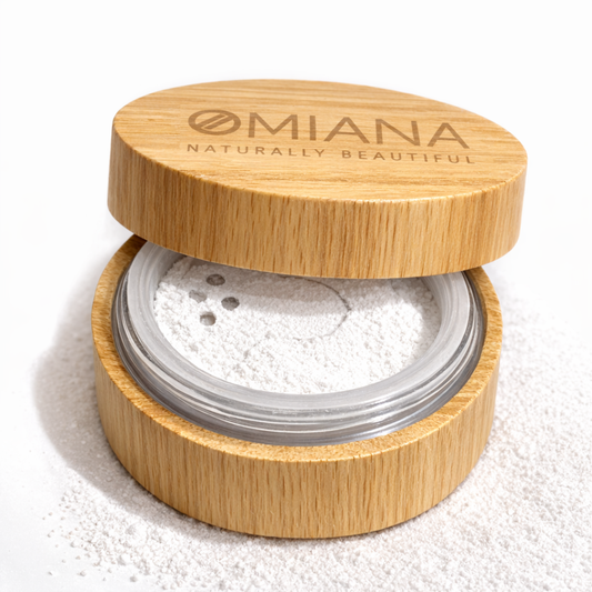 Open wooden container of Omiana Mineral Veil finishing powder titanium dioxide-free mineral makeup in Bamboo container with white powder on a white background